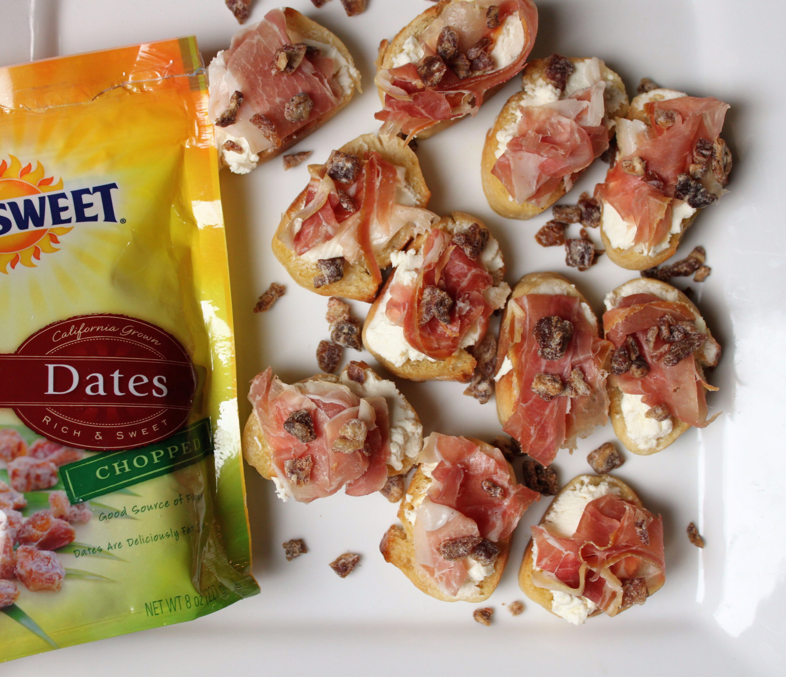 Easy recipe appetizer for honey goat cheese and prosciutto recipe topped with Sunsweet Dates.