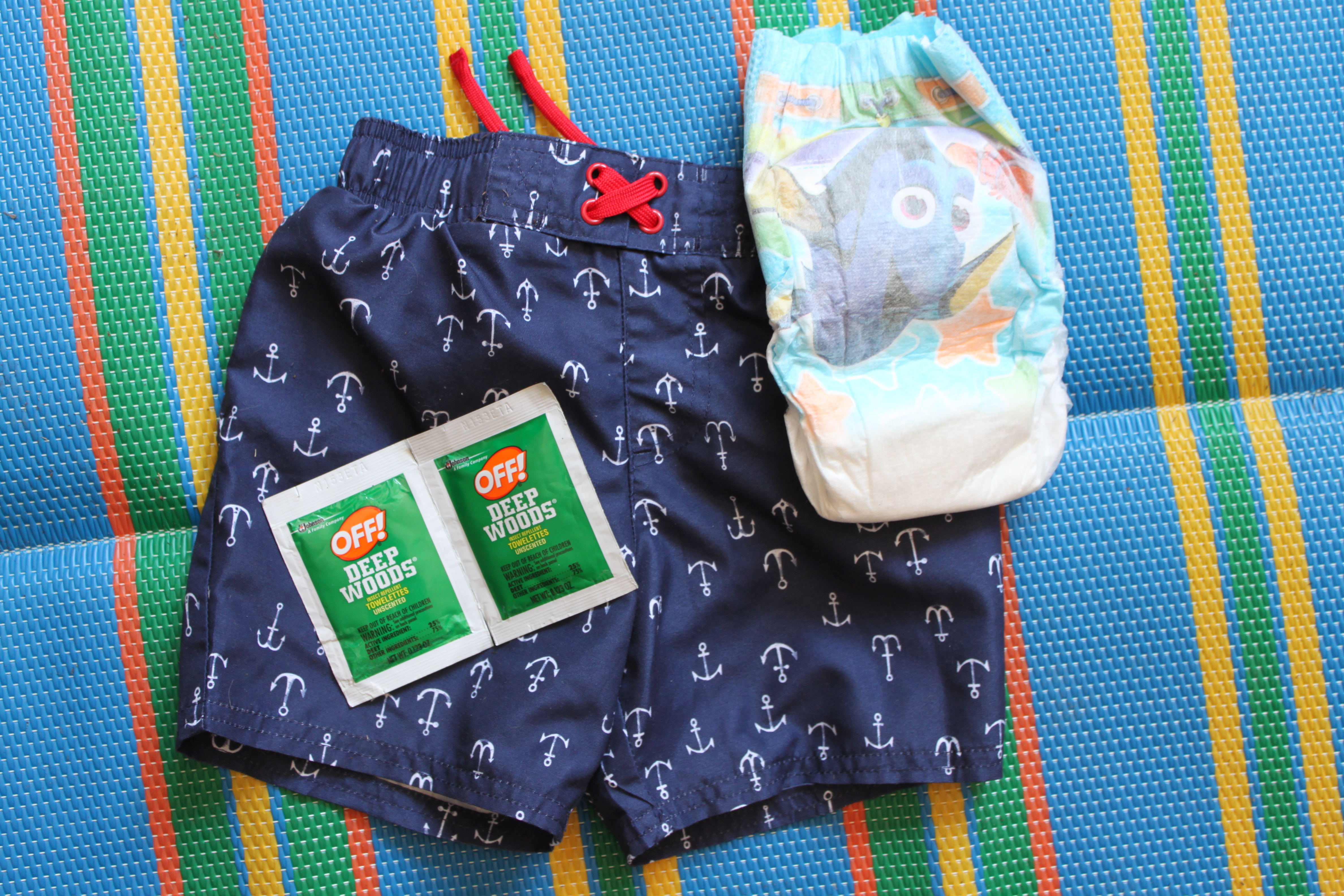 summer essentials for mom and toddler for parks, beach, and pool. Sunscreen, skin and hair products. Swim diapers and OFF bug spray wipes