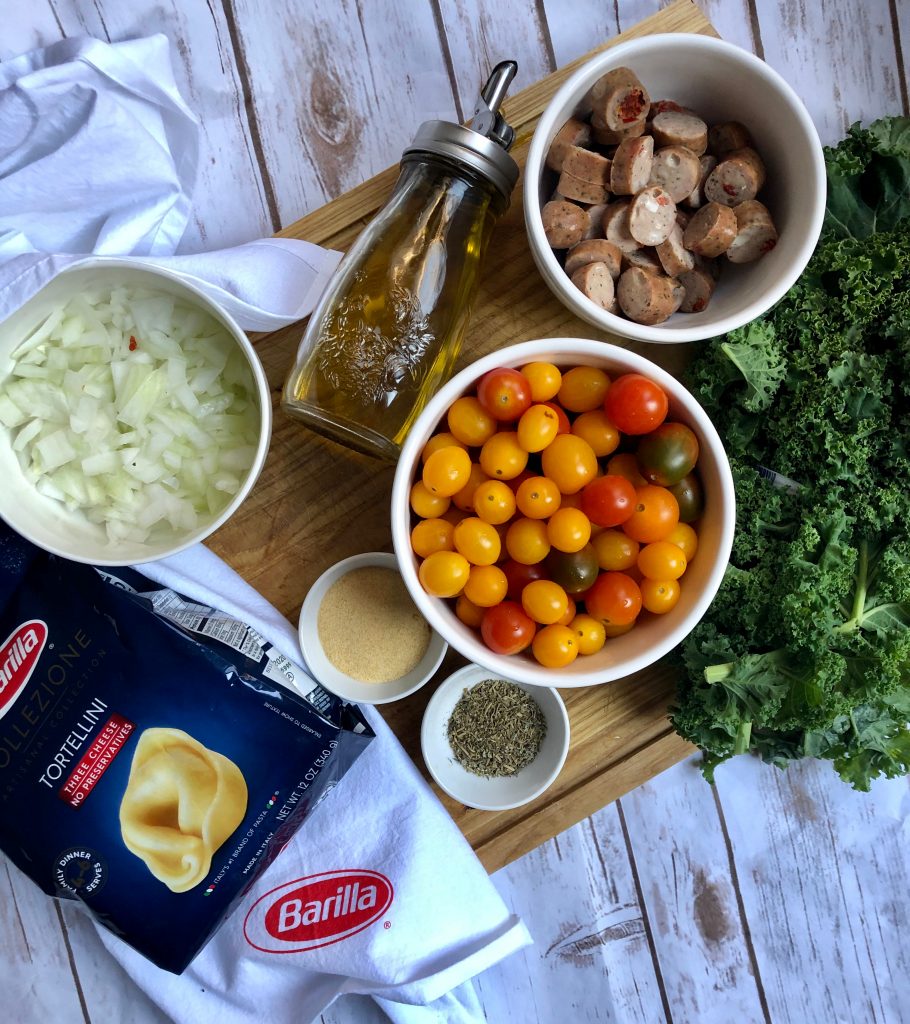 Barilla® Collezione 3 Cheese Tortellini ingredients to make an easy weeknight meal with tomatoes, kale and chicken sausage. Just like a restaurant style dinner! 